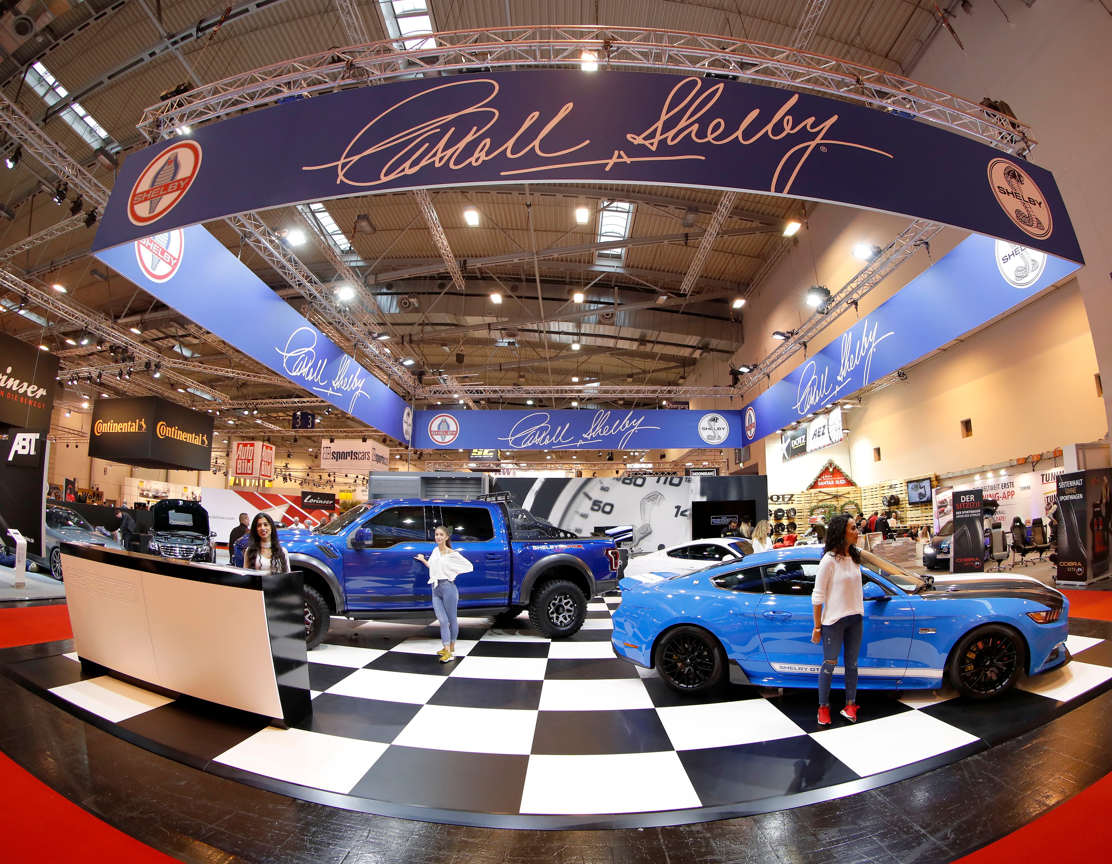Shelby Europe stand at Essen Motor Show — blue F-150 Super Snake and GT350 on chequered floor