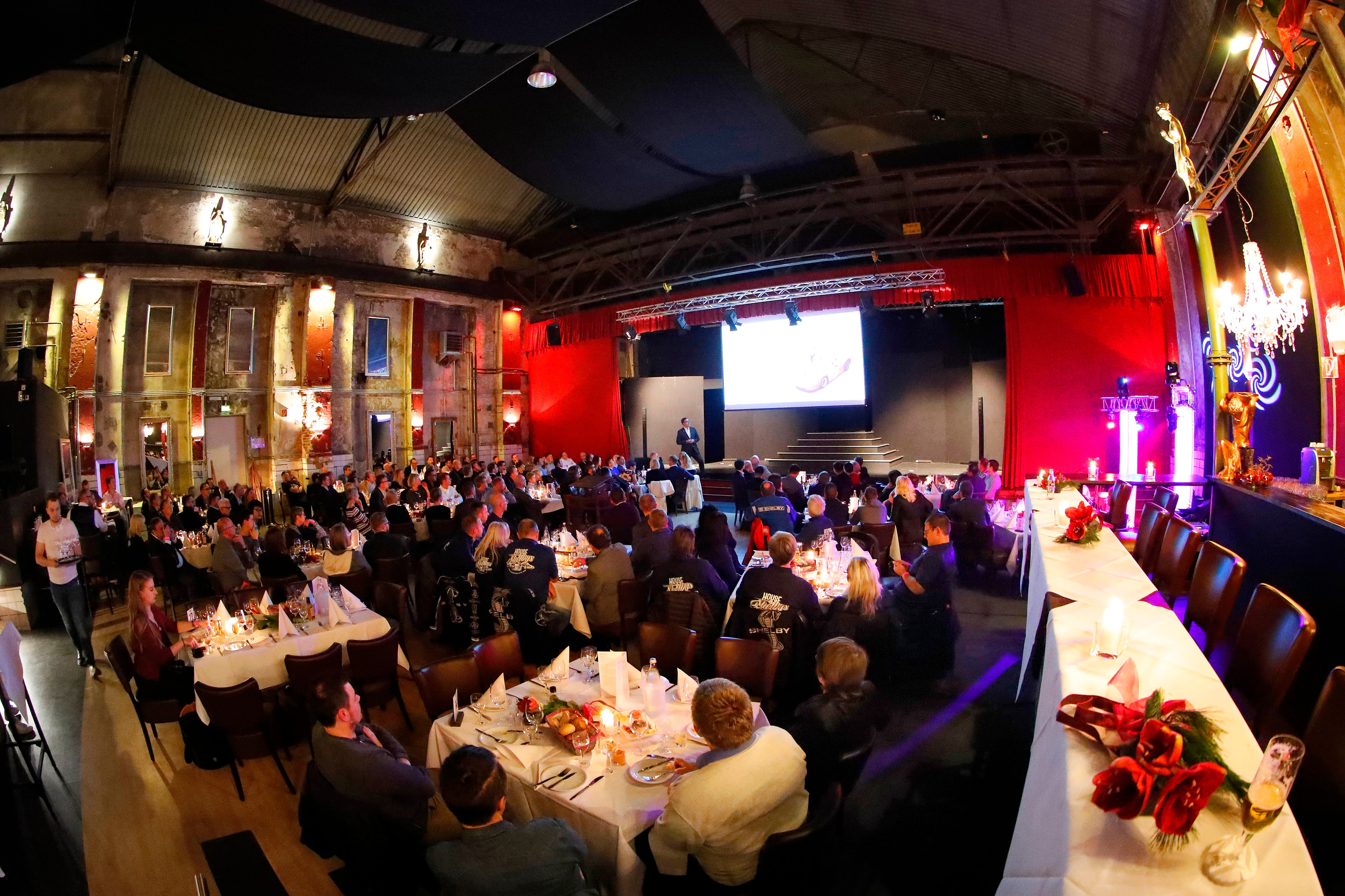 Shelby Europe gala dinner — full venue with guests and presentation screen