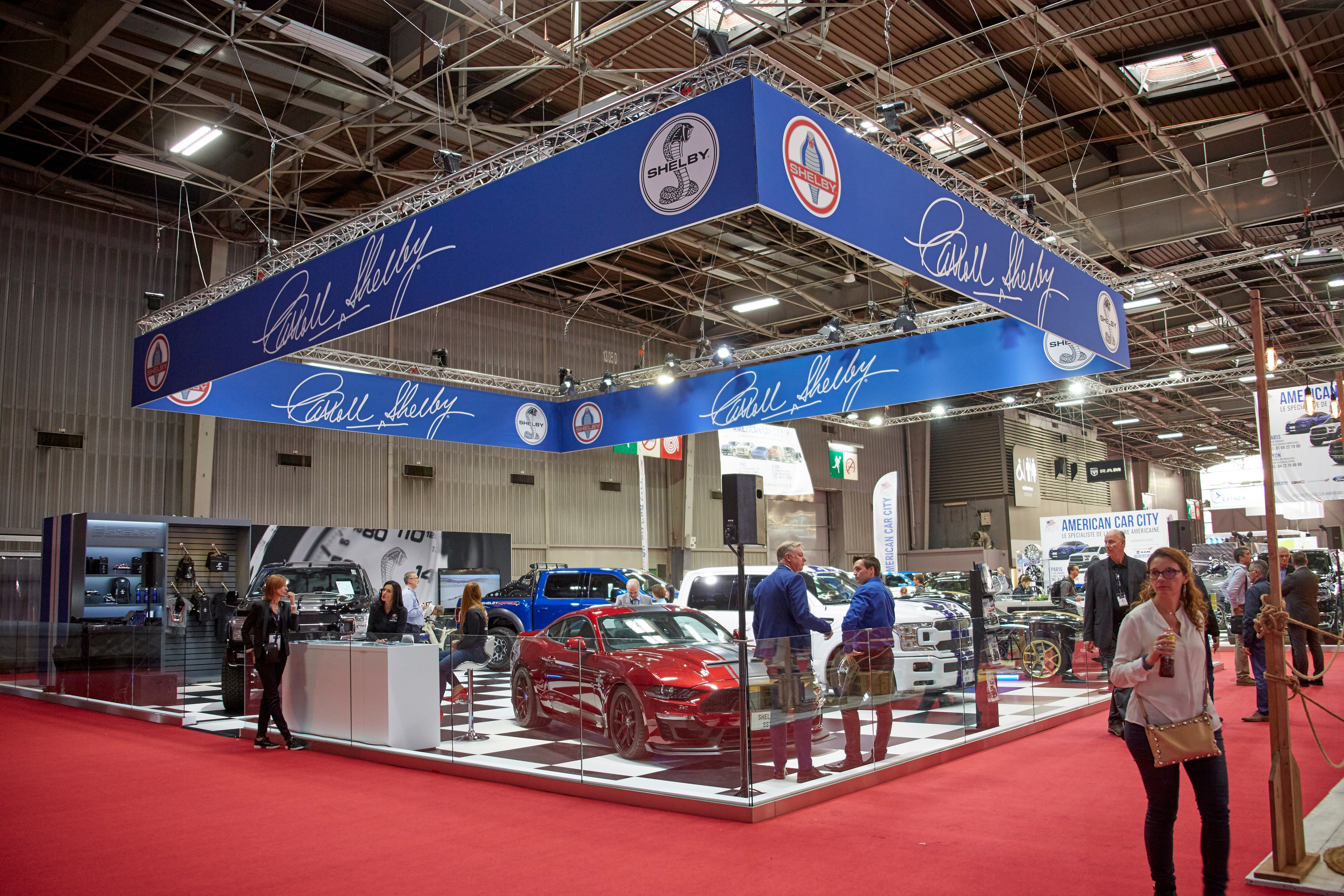 Shelby Europe stand at Interclassics — red Super Snake and blue F-150 on display